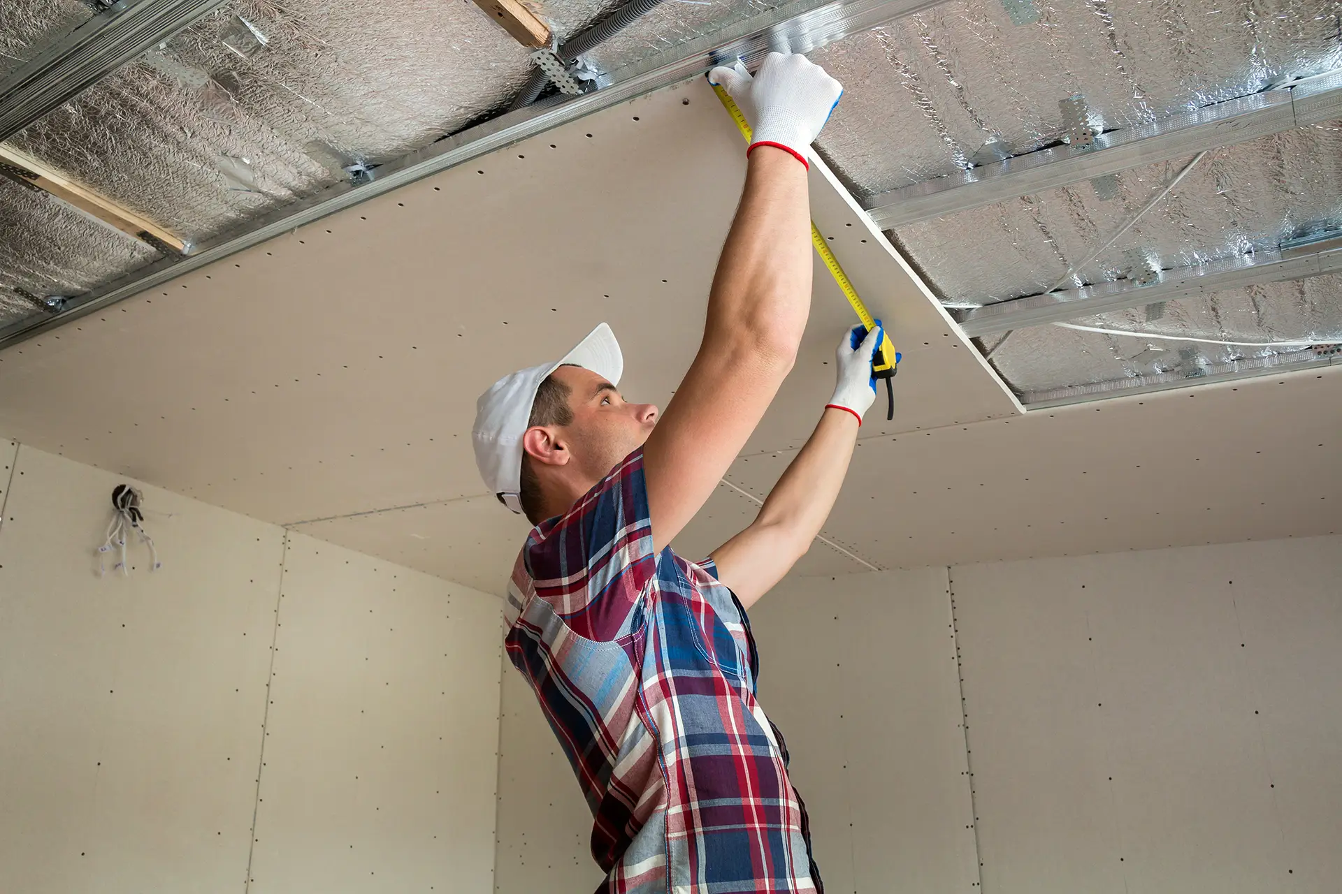 Gabes Pty Ltd technician inspecting ceiling panels – expert commercial cleaning & post-construction surface maintenance